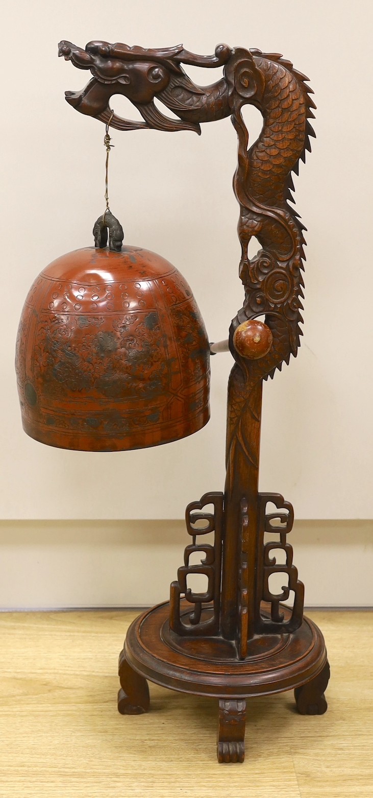 A Chinese carved hongmu 'dragon' stand with Japanese bell, 73cm tall